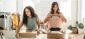 two women packing orders for their small business