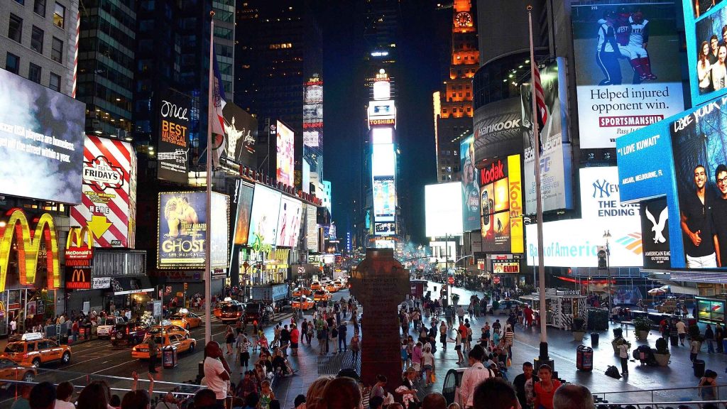 Photo of Times Square - featuring mcdonalds logo, tgi Fridays logo, kodak logo, bank of america logo, toshiba logo